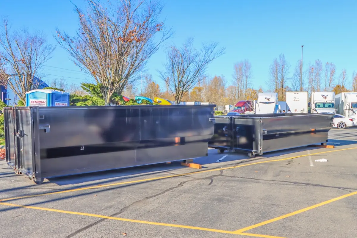 Professional dumpster rental service with roll-off container on residential driveway in Spanish Lake